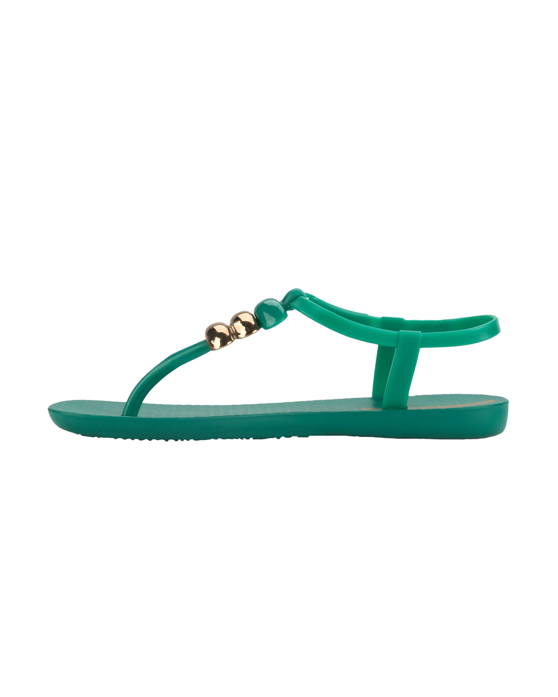 Inner side view of a green Ipanema Class women's sandal with 3 bubble baubles on the t-strap.