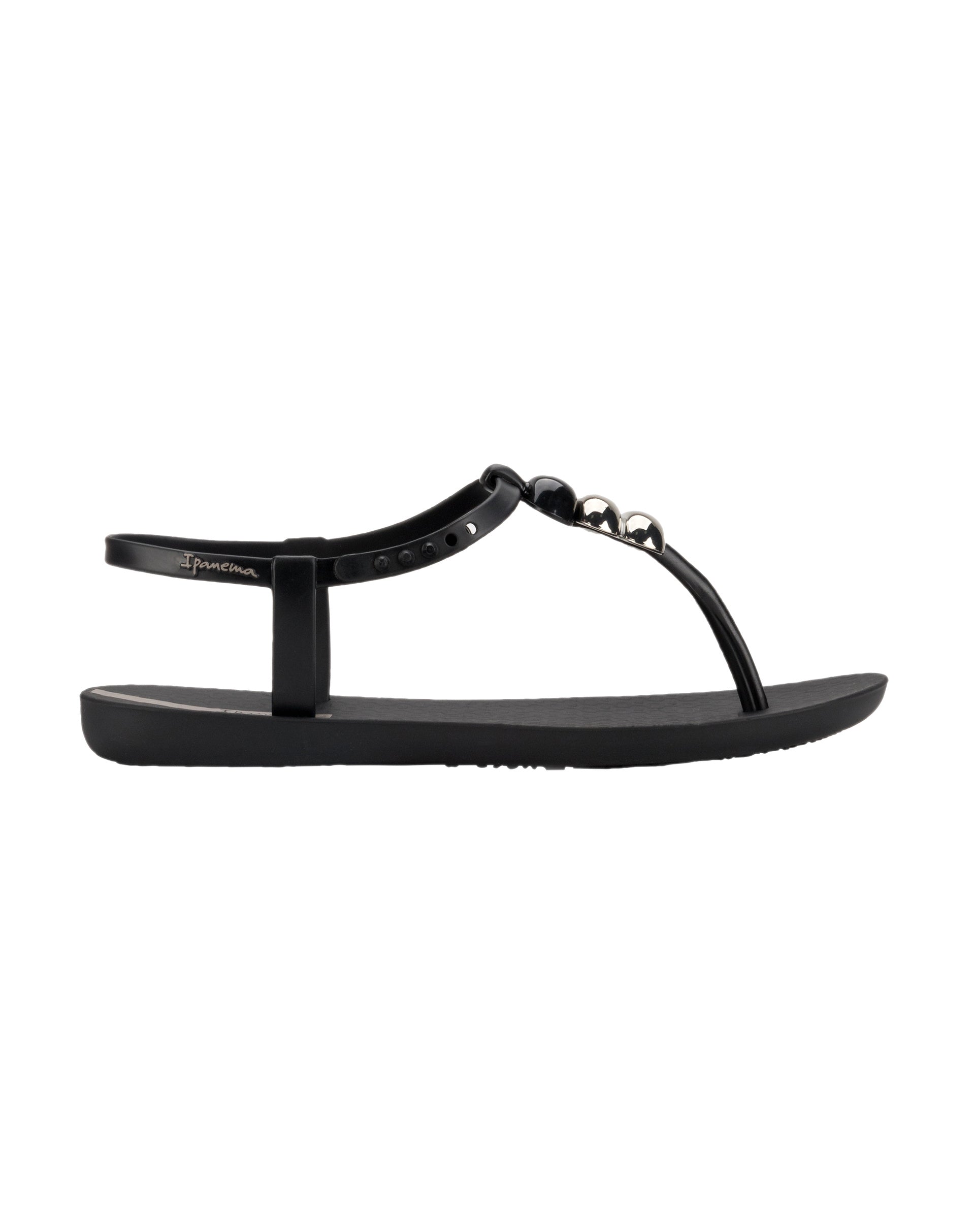 Outer side view of a black Ipanema Class women's sandal with 3 bubble baubles on the t-strap.