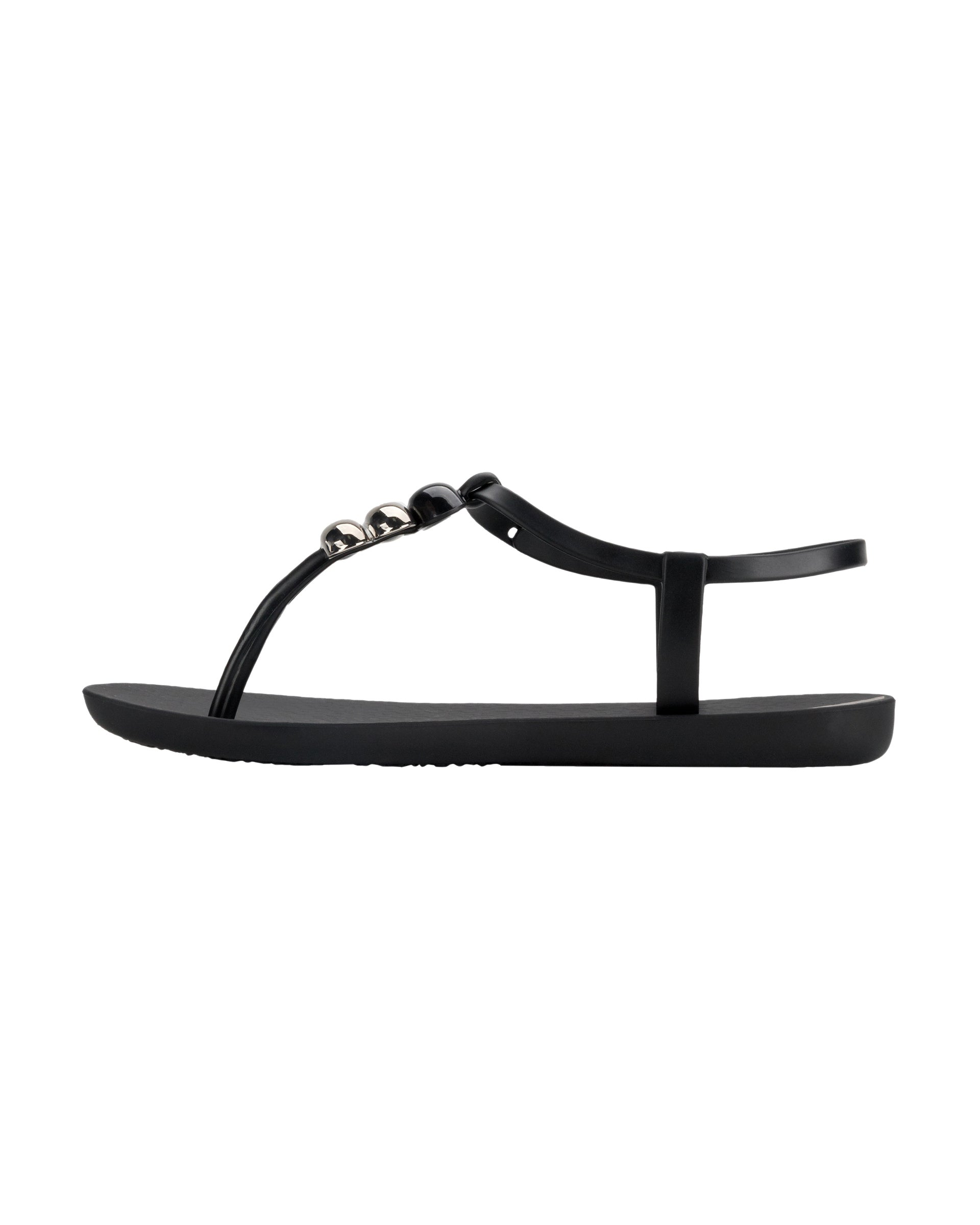 Inner side view of a black Ipanema Class women's sandal with 3 bubble baubles on the t-strap.