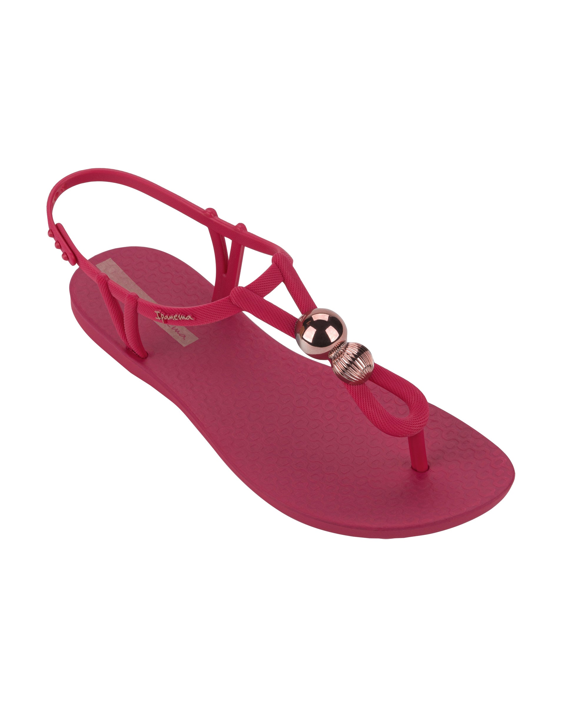 Angled view of a pink Ipanema Class Spheres women's t-strap sandal with metallic bauble.