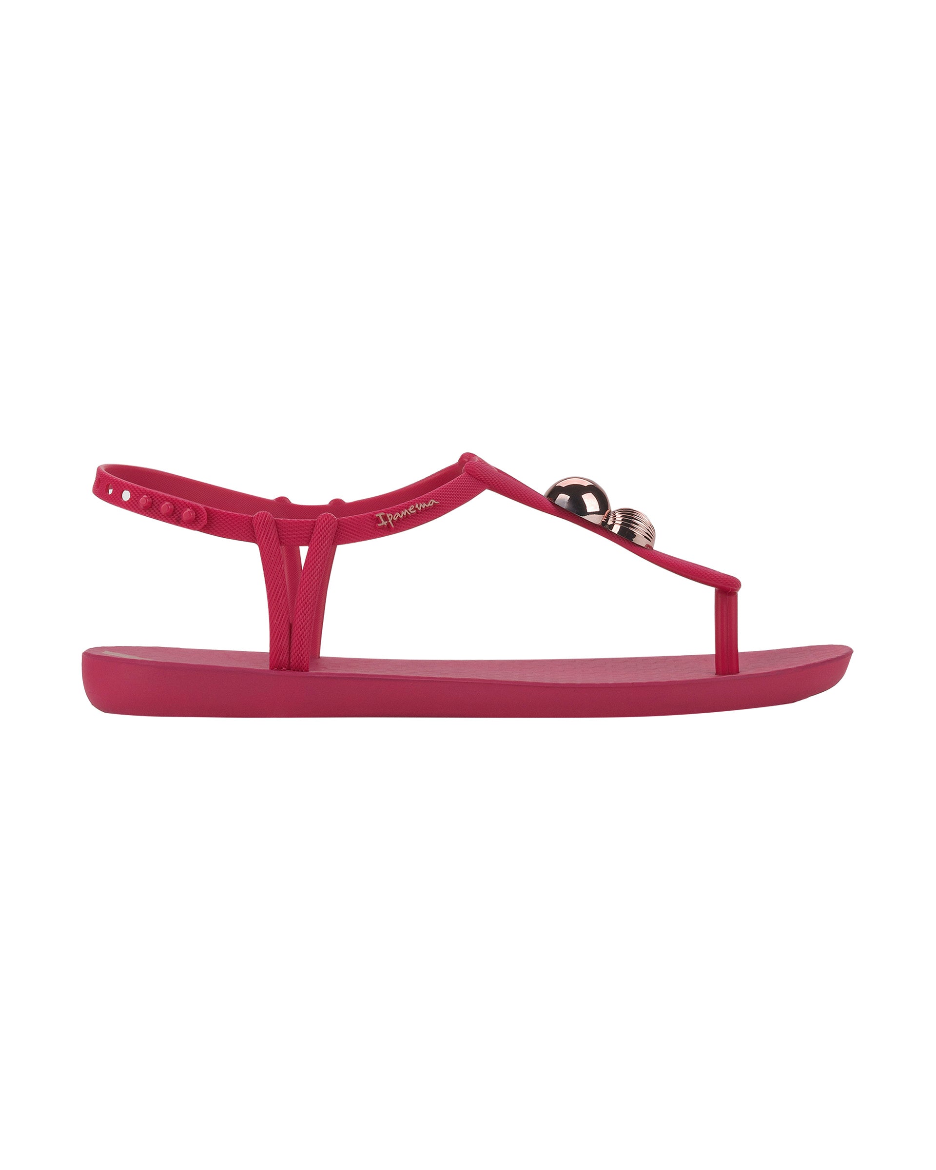 Outer side view of a pink Ipanema Class Spheres women's t-strap sandal with metallic bauble.