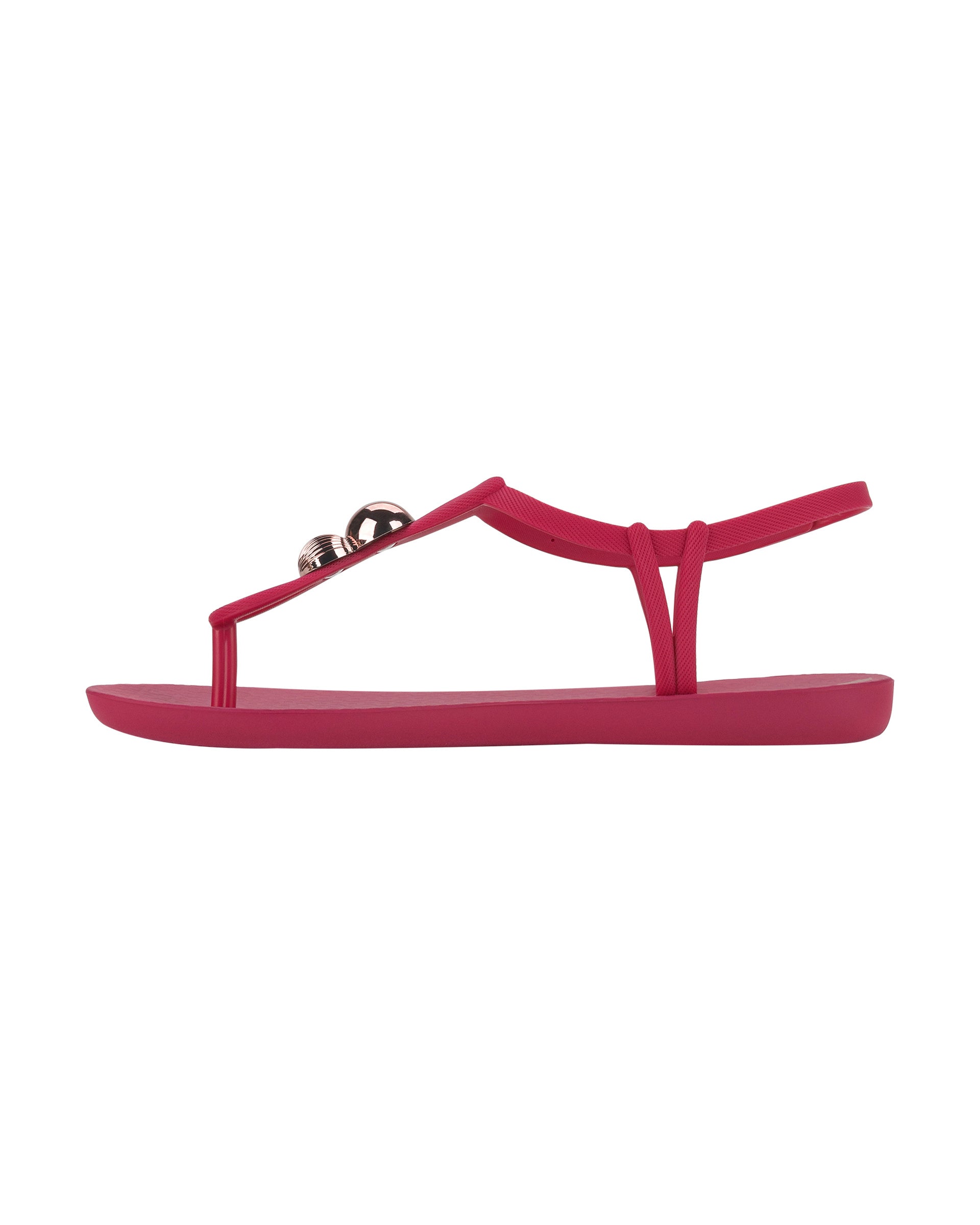 Inner side view of a pink Ipanema Class Spheres women's t-strap sandal with metallic bauble.
