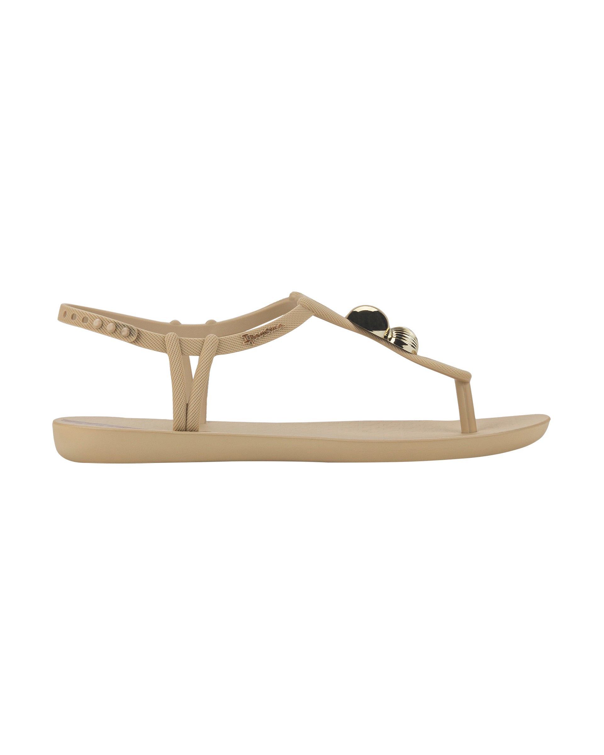 Outer side view of a beige Ipanema Class Spheres women's t-strap sandal with metallic bauble.
