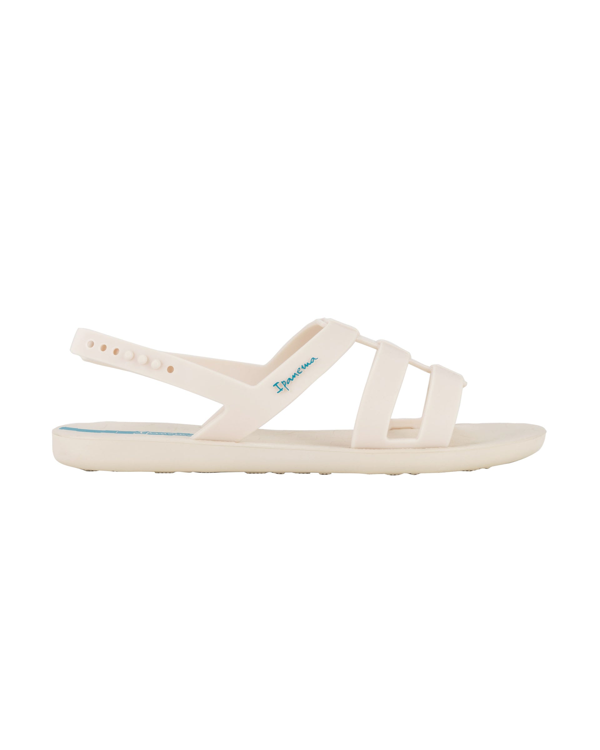 Outer side view of a beige Ipanema Style women's sandal.