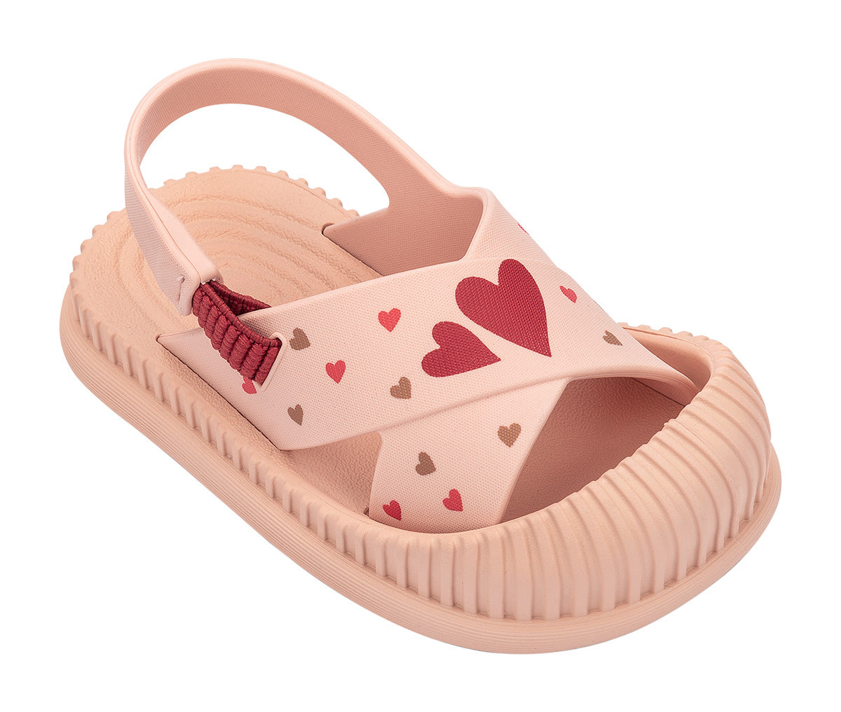 Angled view of a beige Ipanema Cute baby sandal with hearts on the strap.