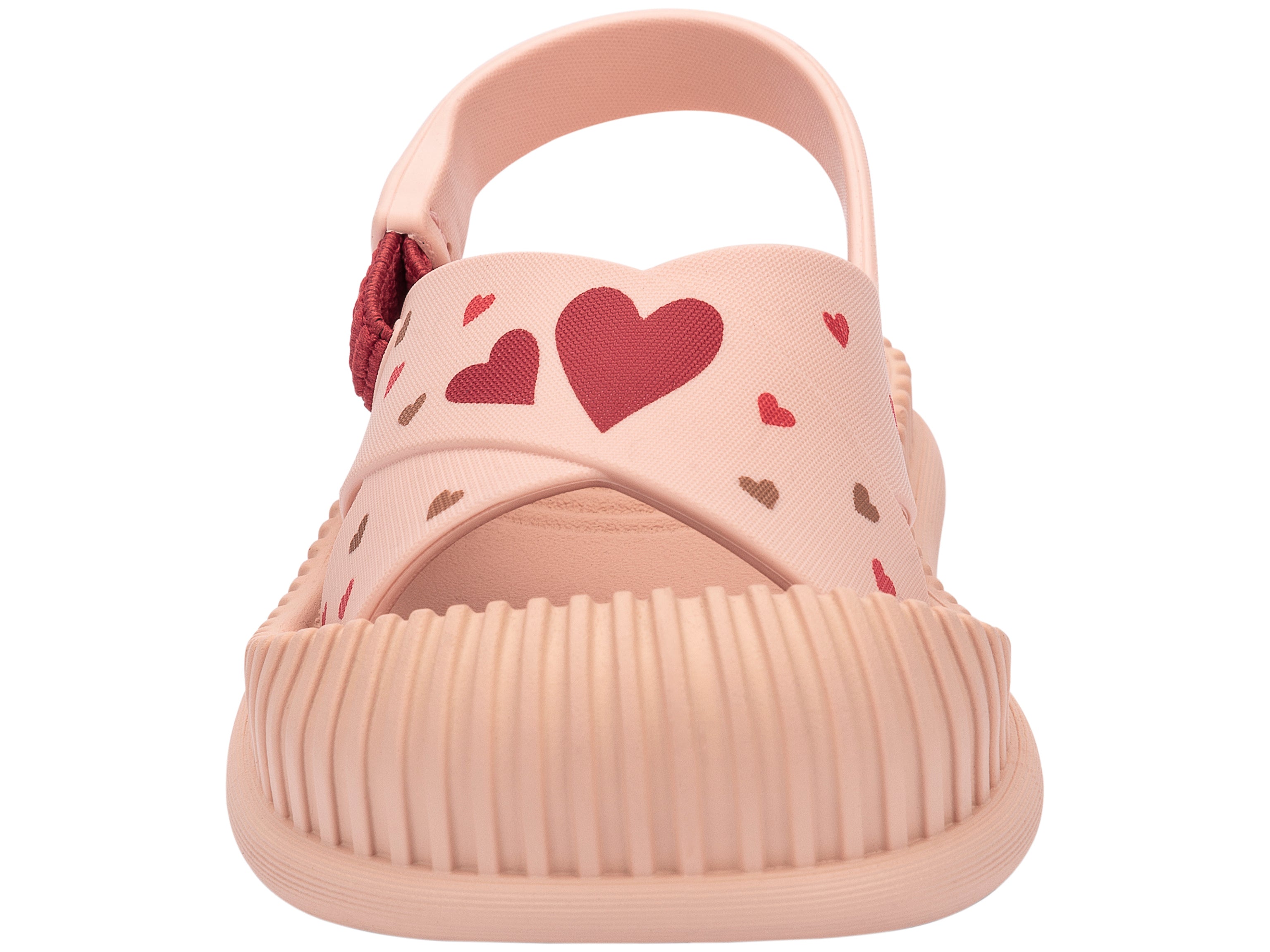 Front view of a beige Ipanema Cute baby sandal with hearts on the strap.