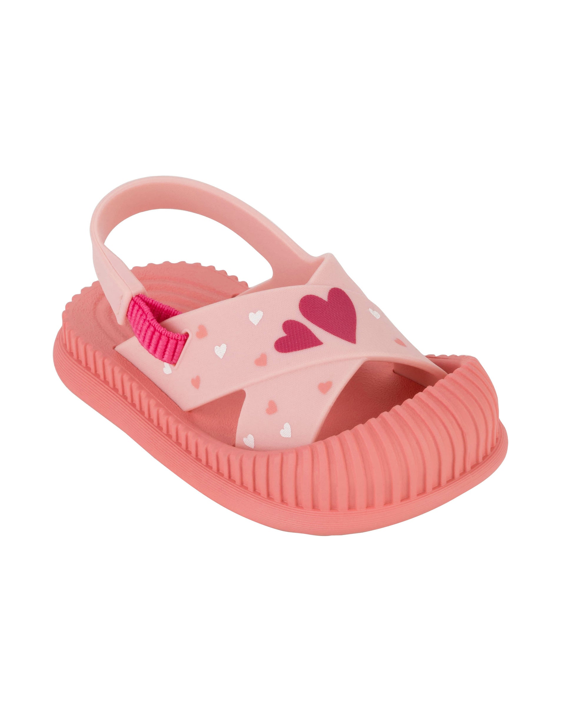 Angled view of a pink Ipanema Cute baby sandal with hearts on the strap.