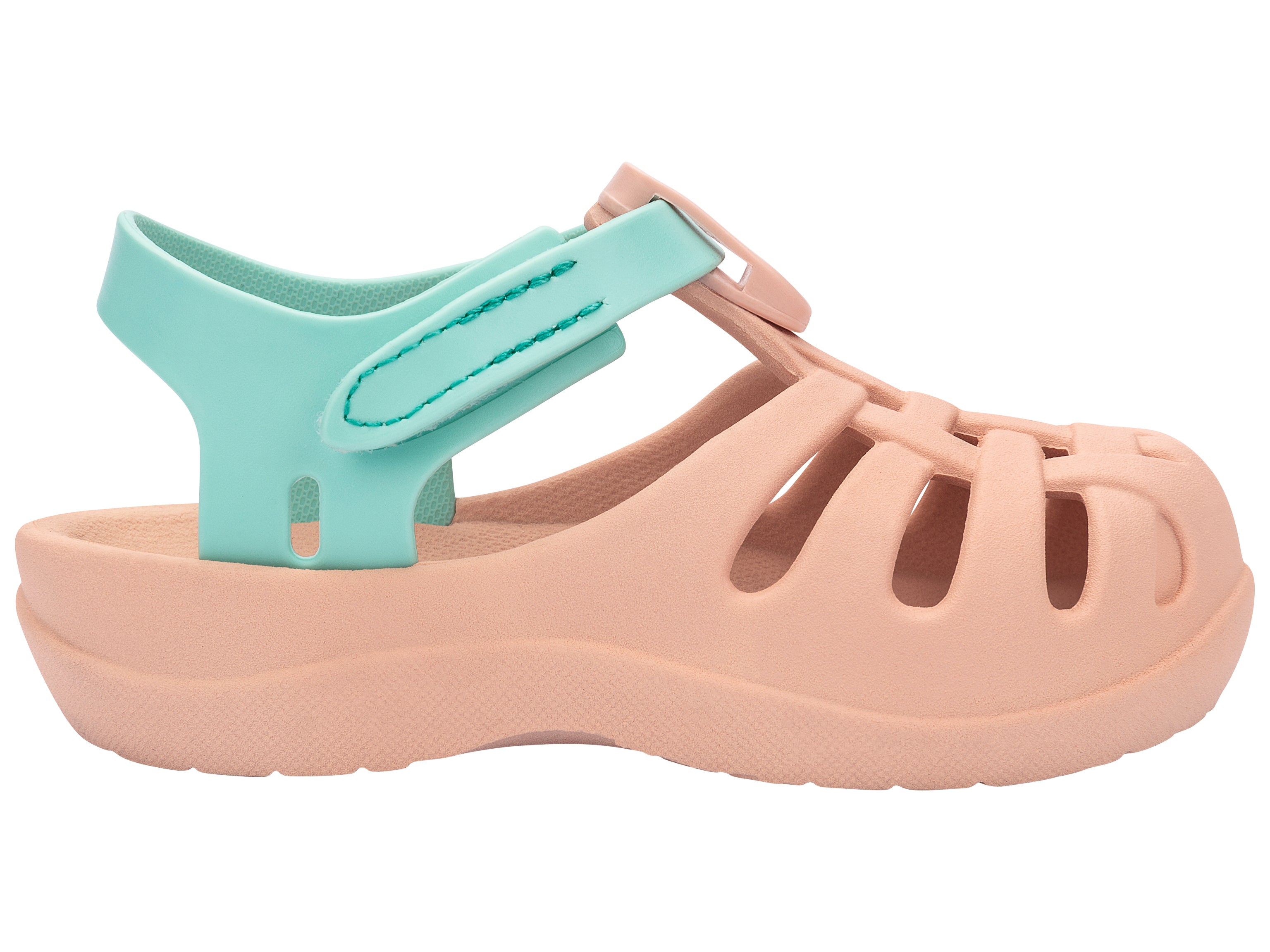 Outer side view of a beige Ipanema Summer Basic baby sandal with green strap.