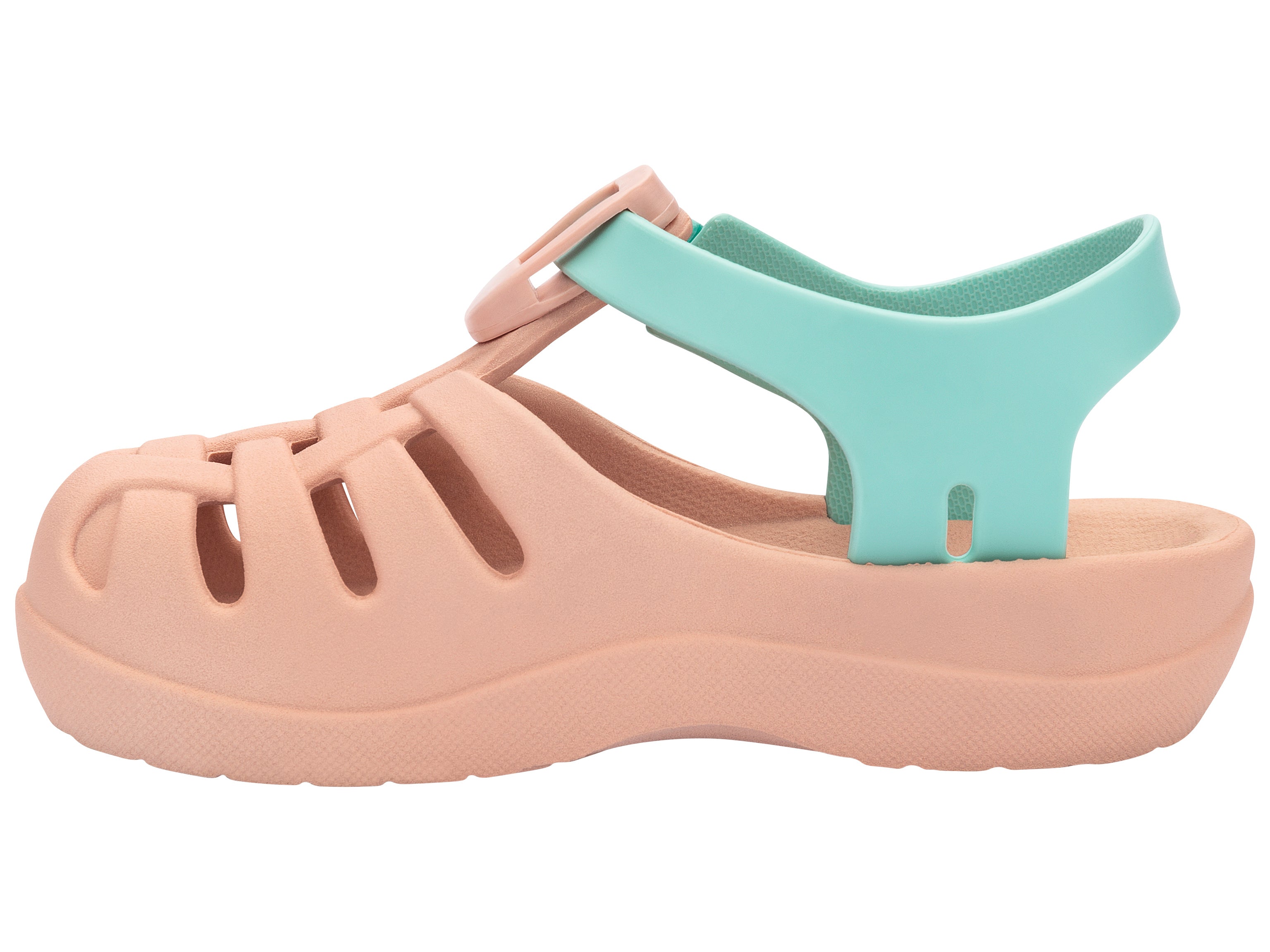 Inner side view of a beige Ipanema Summer Basic baby sandal with green strap.