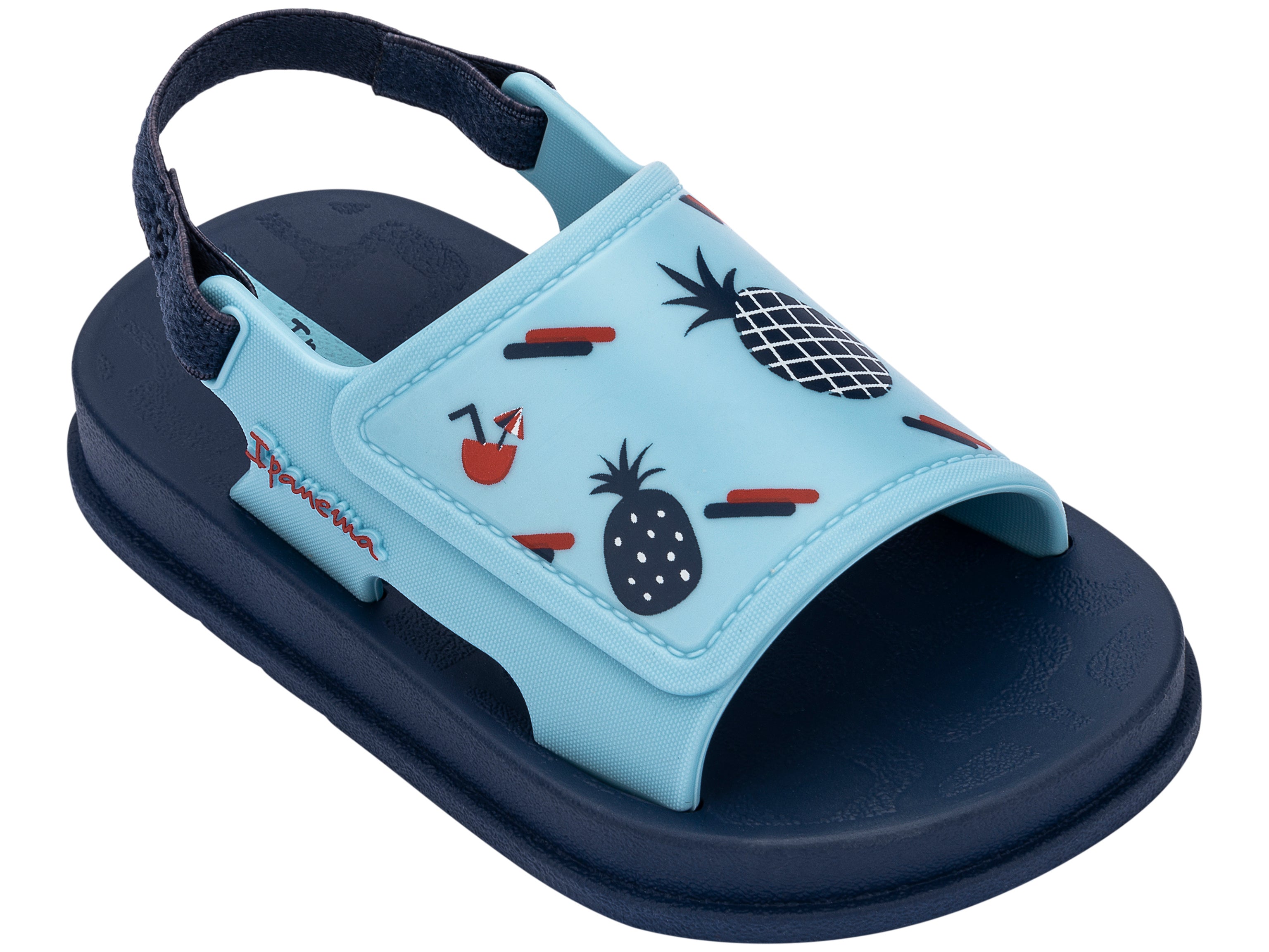 Angled view of a blue Ipanema Soft baby sandal with fruit print on the upper.