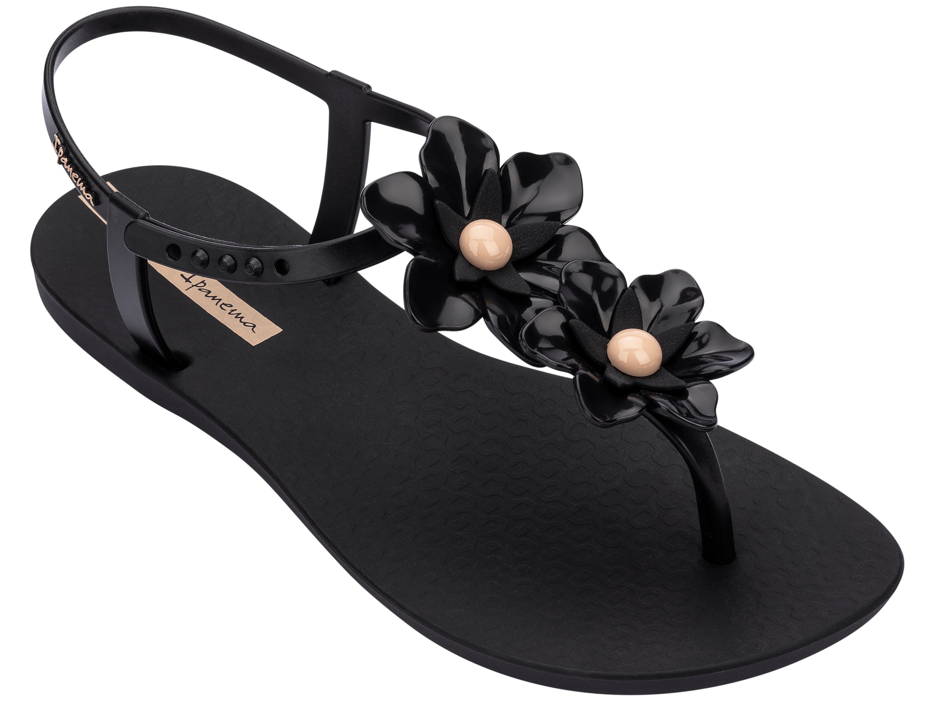 Angled view of a black Ipanema Duo Flowers women's t-strap sandal with two flowers.