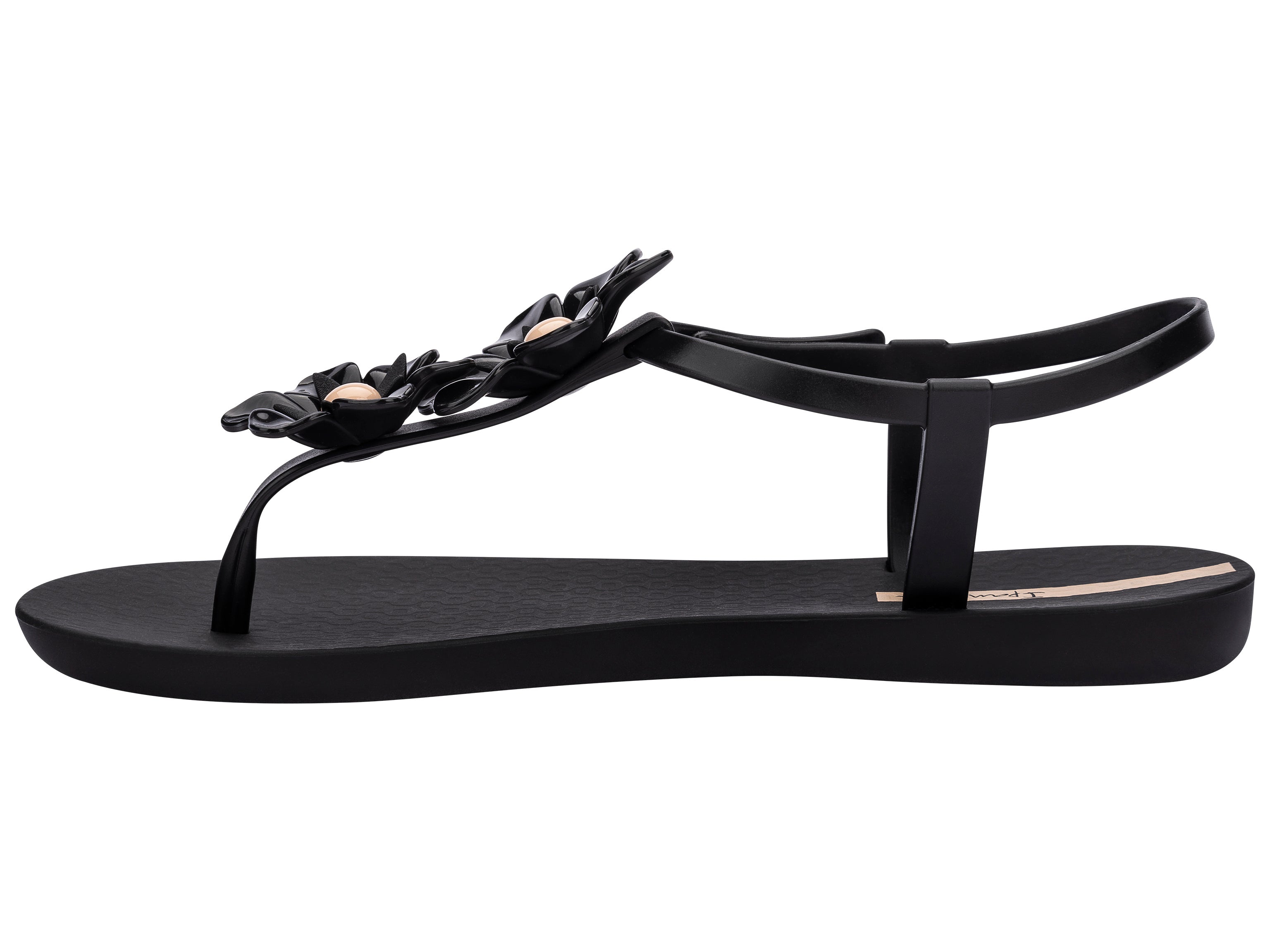 Inner side view of a black Ipanema Duo Flowers women's t-strap sandal with two flowers.
