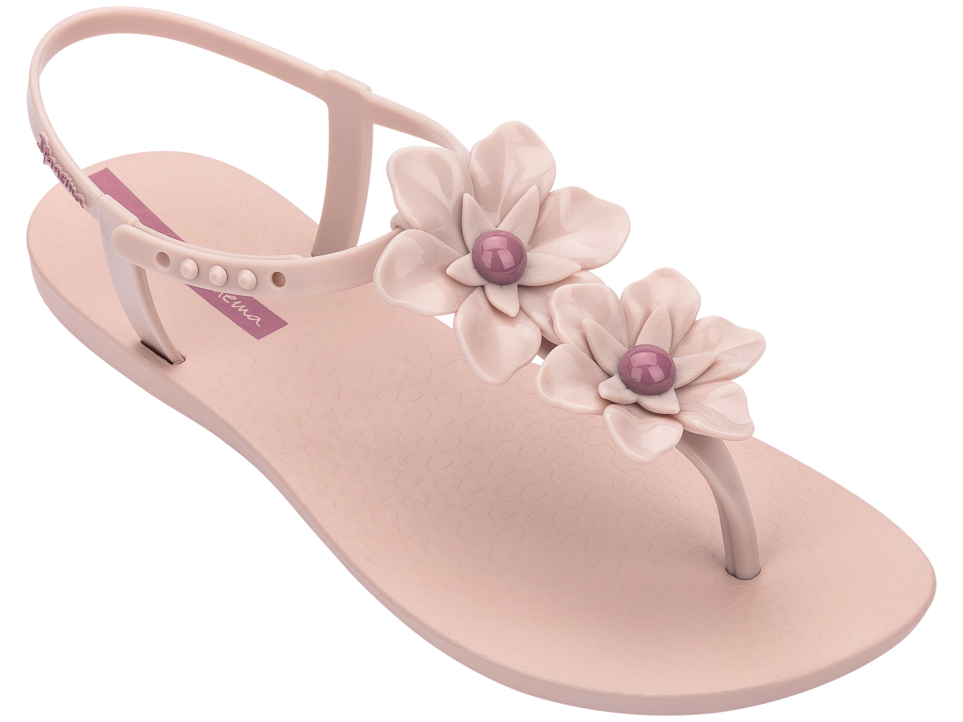 Angled view of a pink Ipanema Duo Flowers women's t-strap sandal with two flowers.