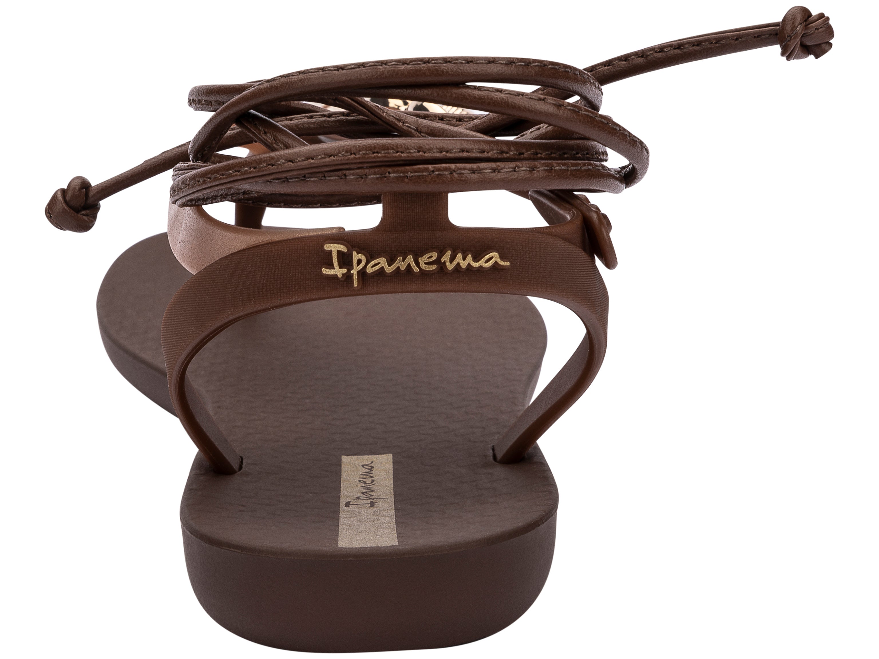 Back view of a brown Ipanema Salty Strappy women's sandal with ankle tie up and 3 gold shells on the strap.