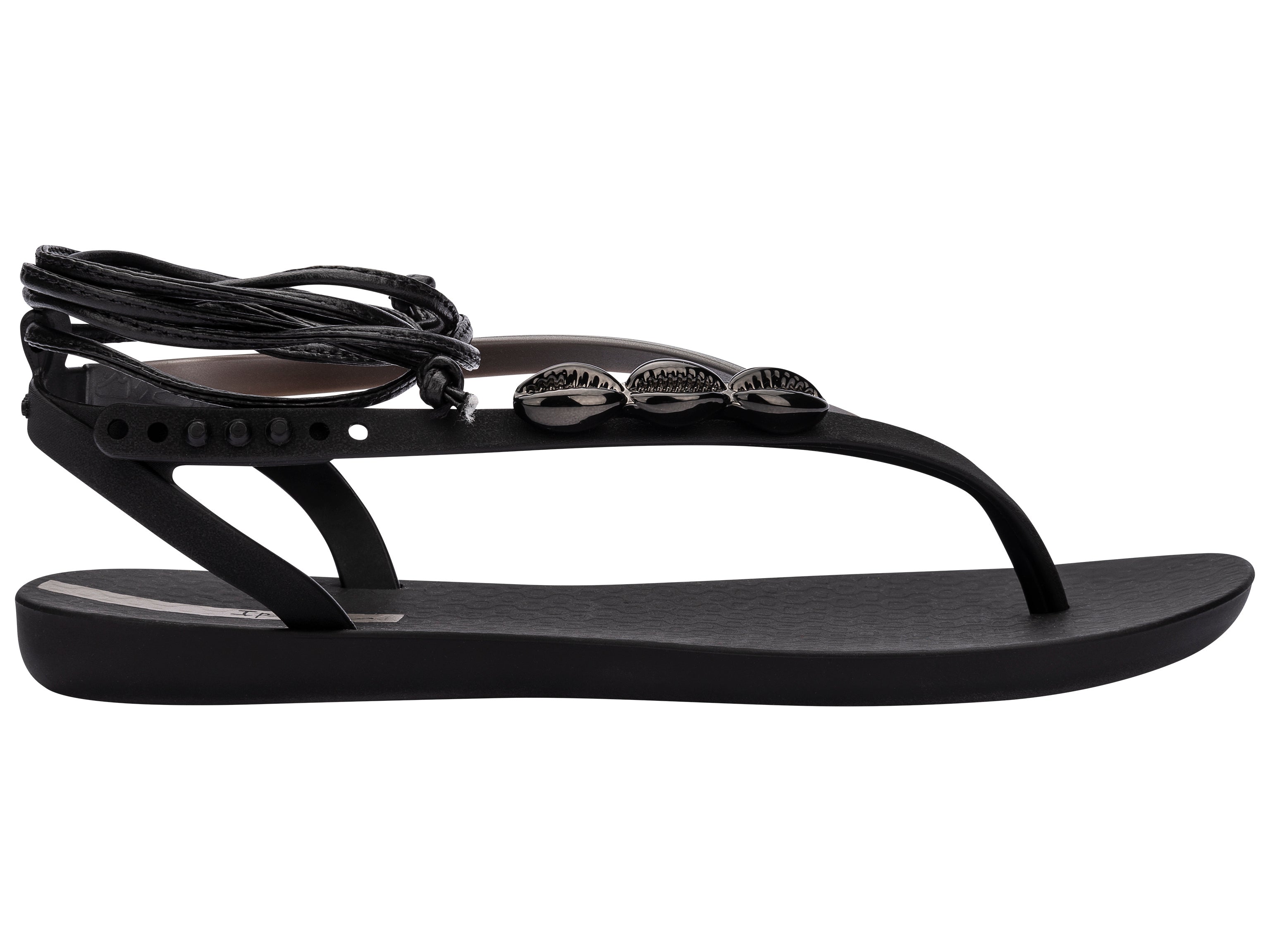 Outer side view of a black Ipanema Salty Strappy women's sandal with ankle tie up and 3 silver shells on the strap.