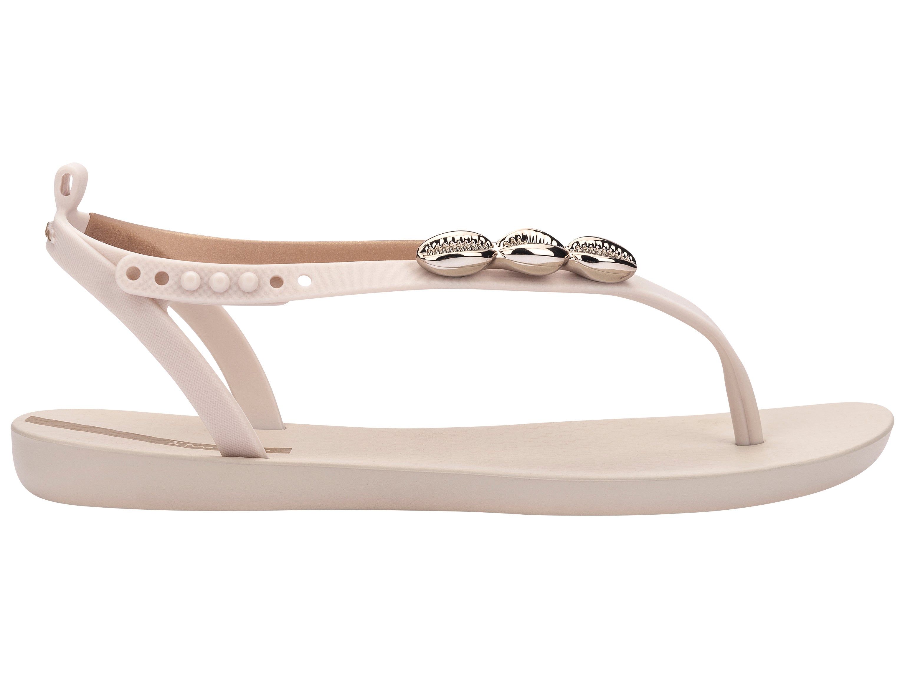 Outer side view of a beige Ipanema Salty women's sandal with 3 gold shells on the strap.