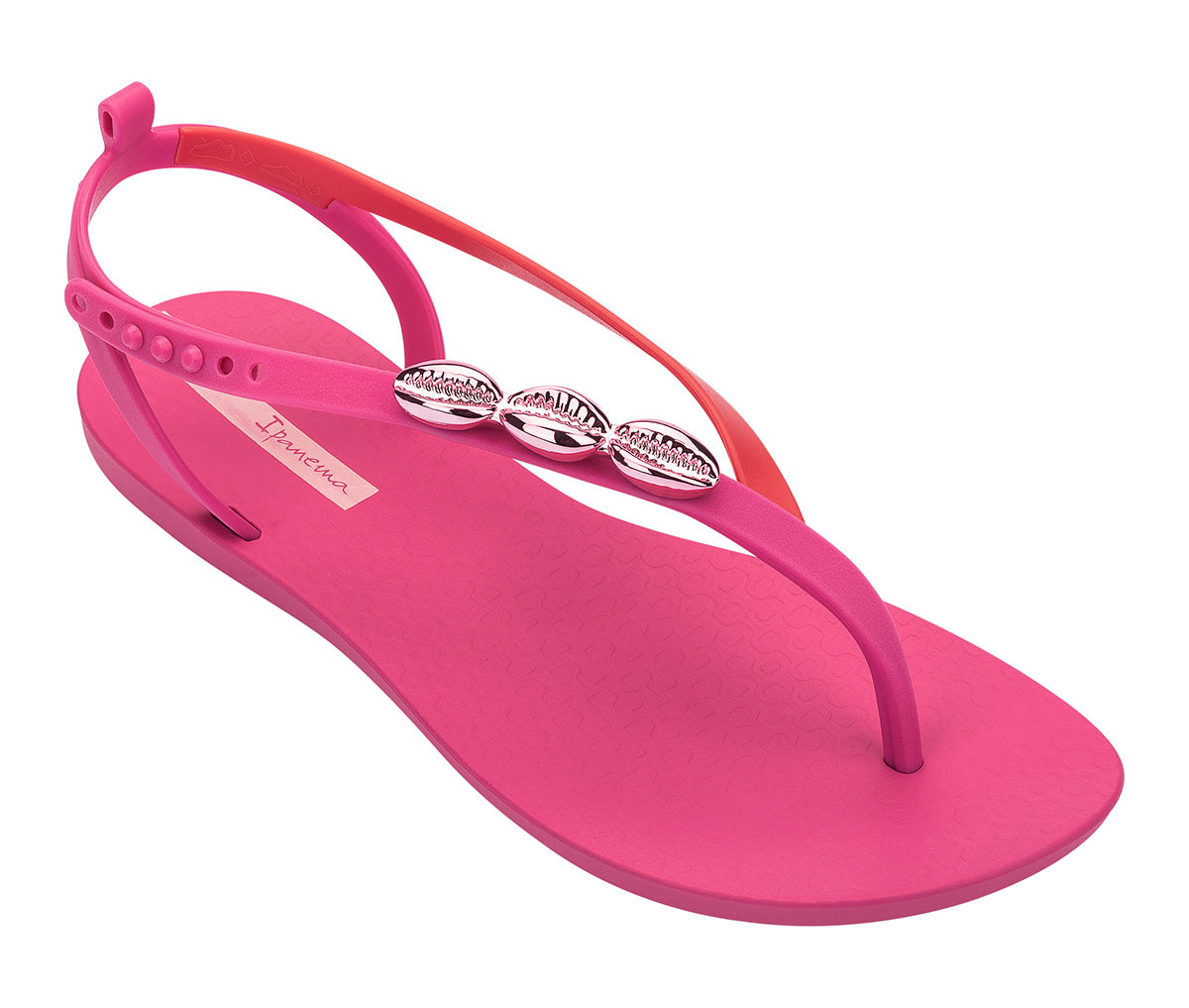 Angled view of a pink Ipanema Salty women's sandal with 3 pink metallic shells on the strap.