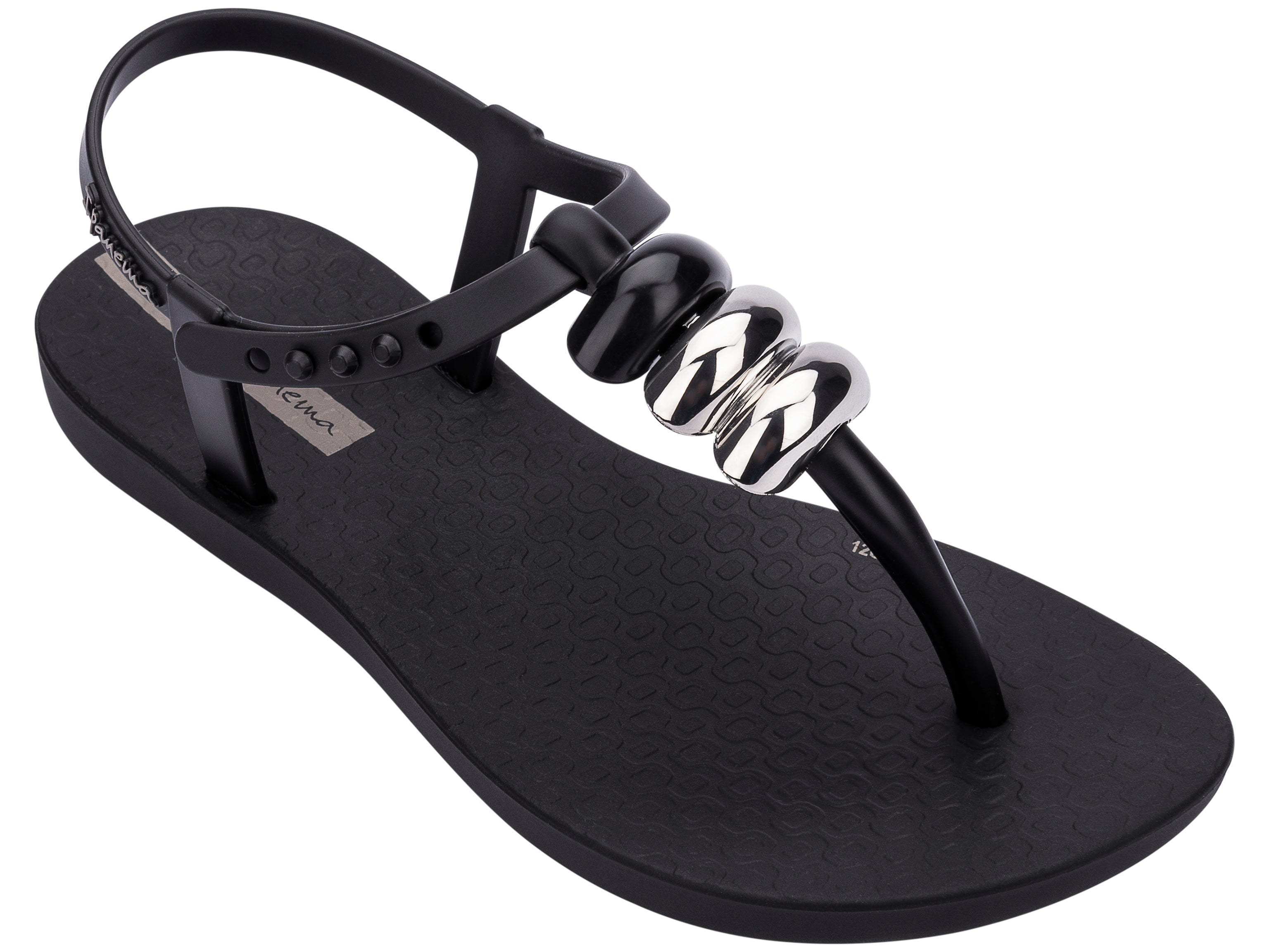 Angled view of a black Ipanema Class kids' t-strap sandal with 3 baubles on the strap.