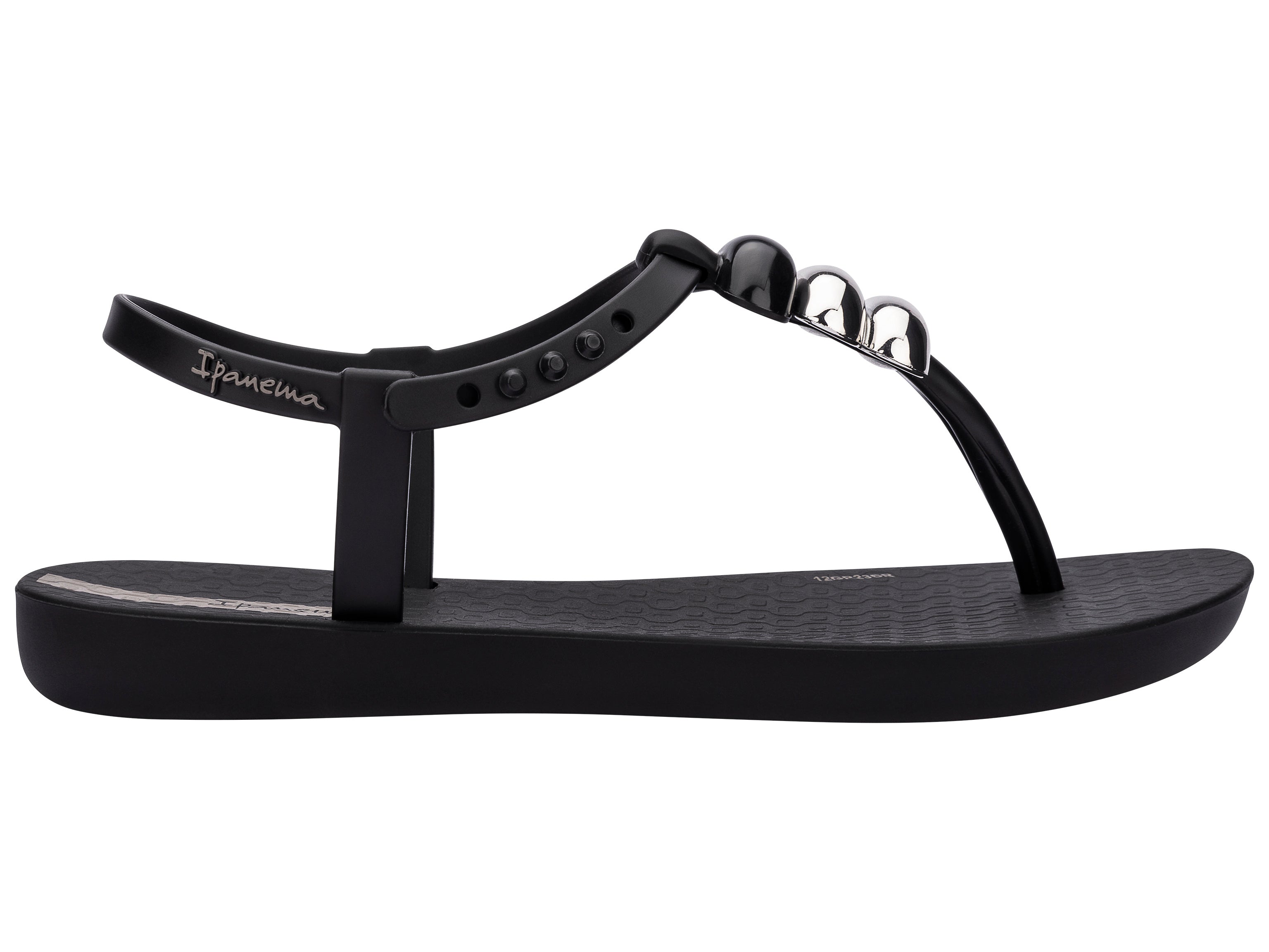 Outer side view of a black Ipanema Class kids' t-strap sandal with 3 baubles on the strap.