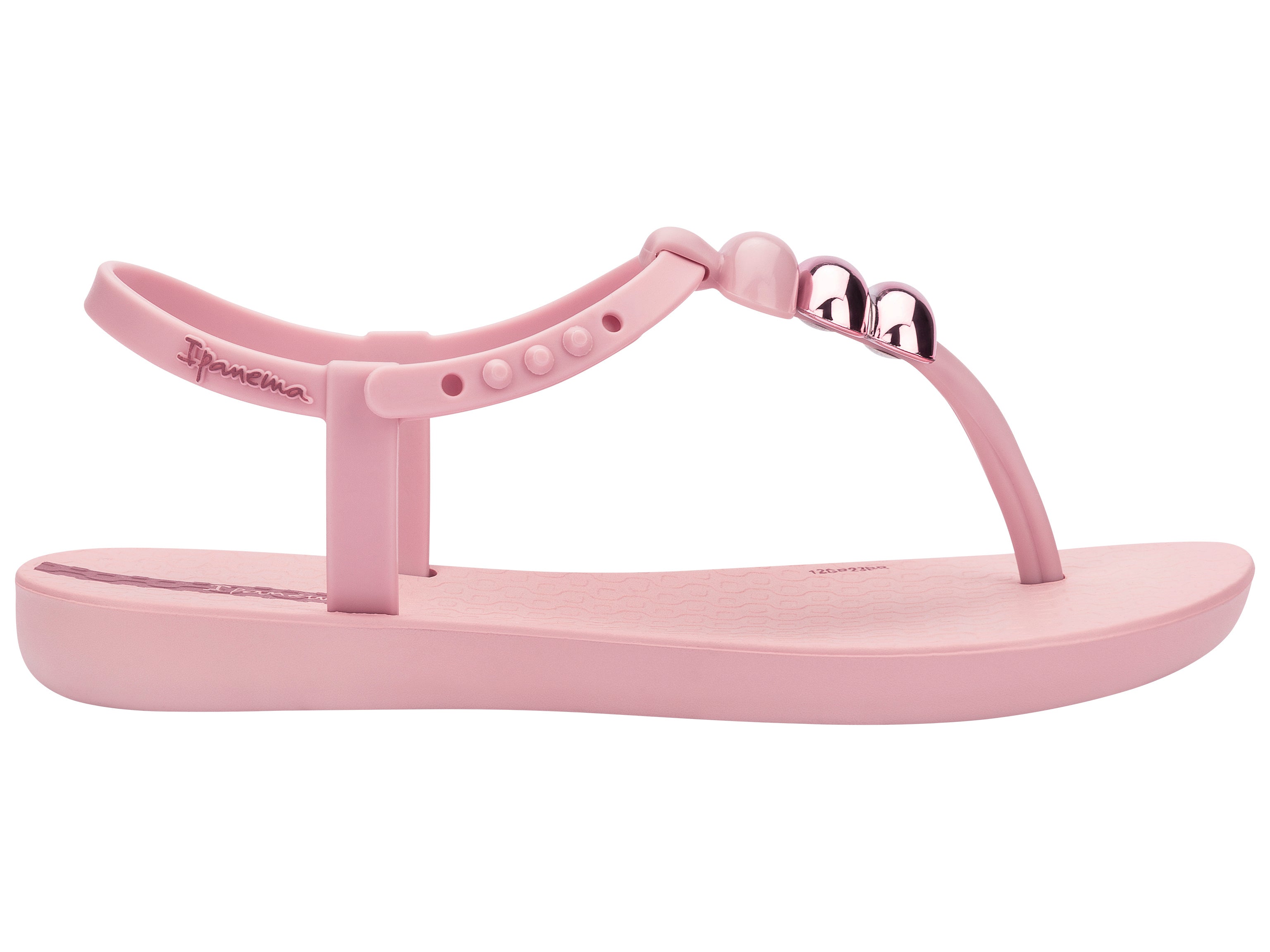 Outer side view of a light pink Ipanema Class kids' t-strap sandal with 3 baubles on the strap.