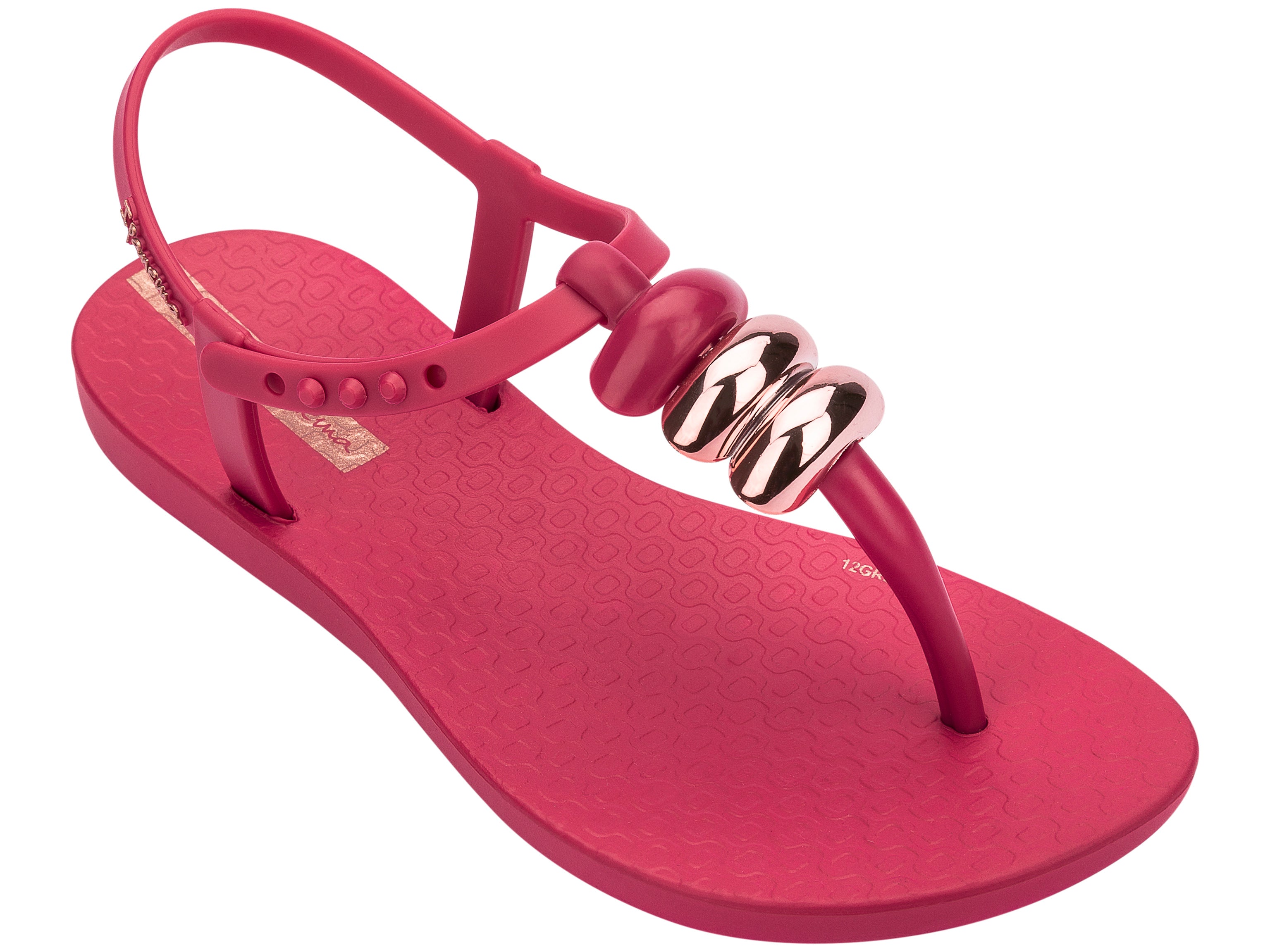 Angled view of a pink Ipanema Class kids' t-strap sandal with 3 baubles on the strap.
