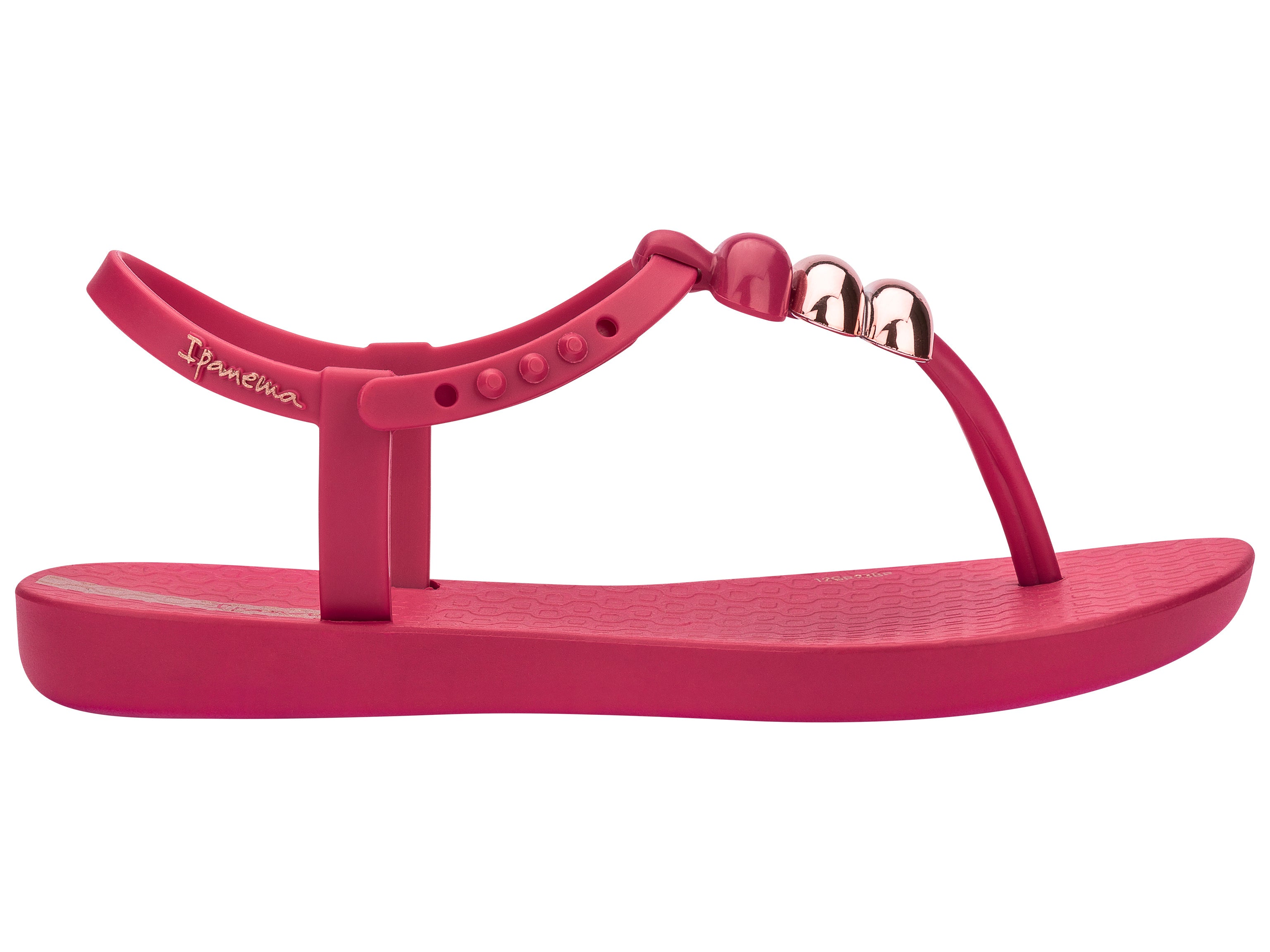 Outer side view of a pink Ipanema Class kids' t-strap sandal with 3 baubles on the strap.